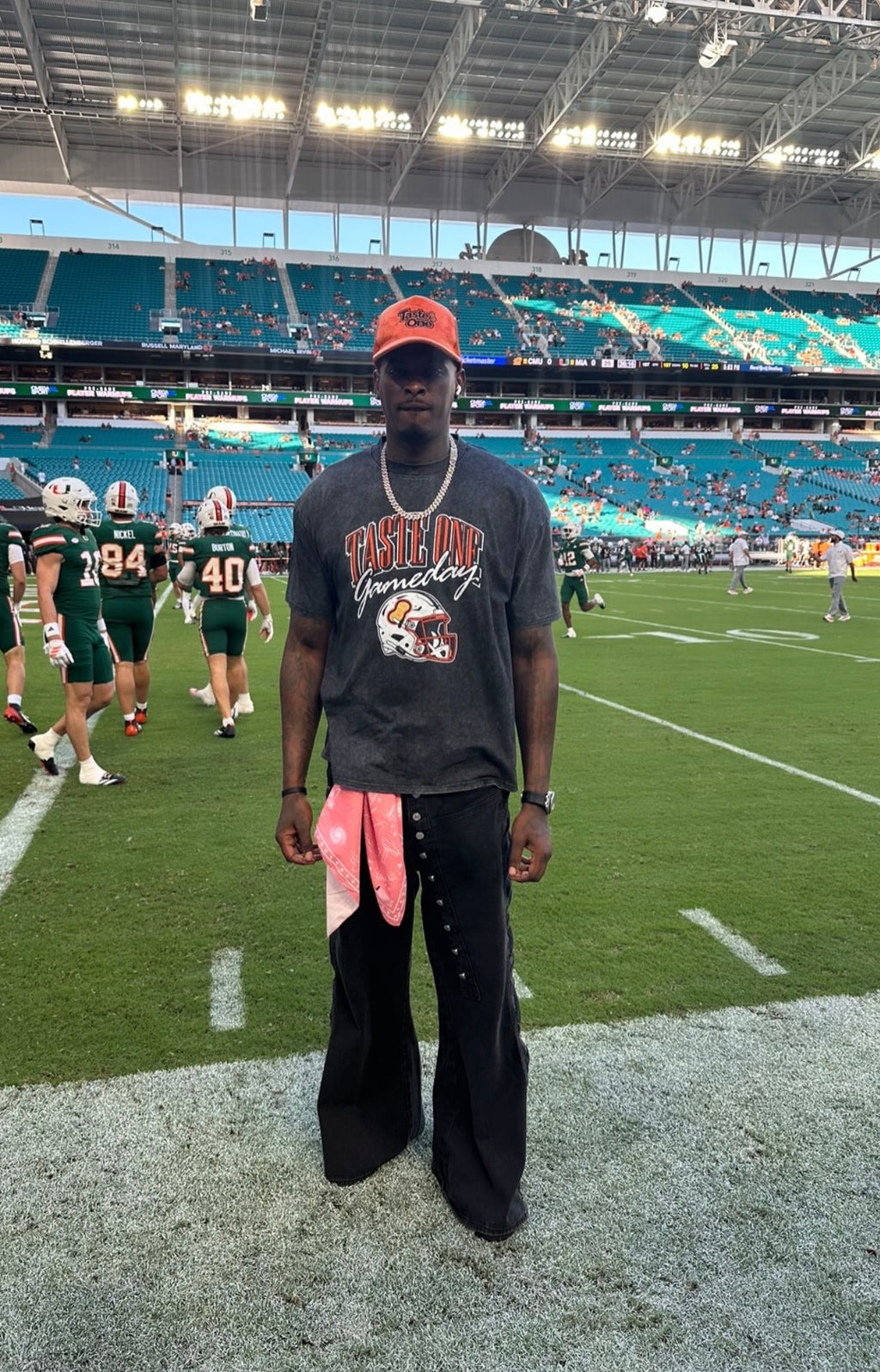 Taste One Gameday Tee worn on the field at Hard Rock Stadium